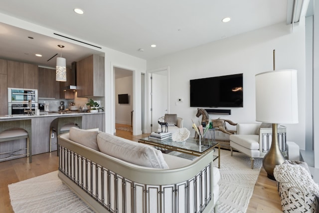 living room featuring light wood-style floors and recessed lighting