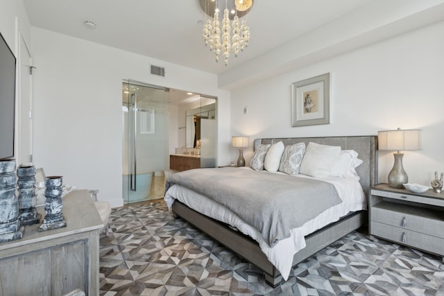 bedroom featuring a chandelier, ensuite bath, and visible vents