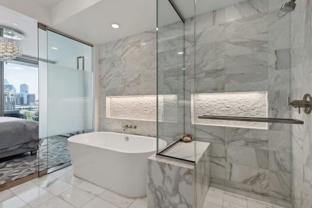 ensuite bathroom with a freestanding tub, tile walls, ensuite bath, a marble finish shower, and marble finish floor