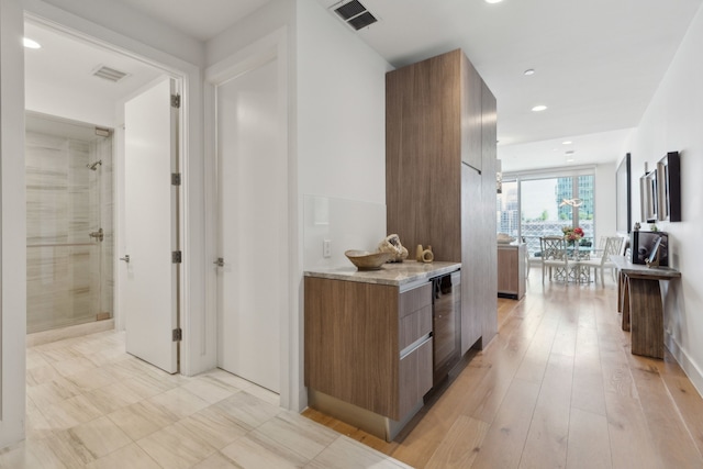 hall with wine cooler, visible vents, light wood-style flooring, and recessed lighting