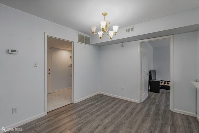 3100 Fairfield Ave Unit 8B, Shreveport, LA 71104 - spare room with a chandelier, wood finished floors, and baseboards