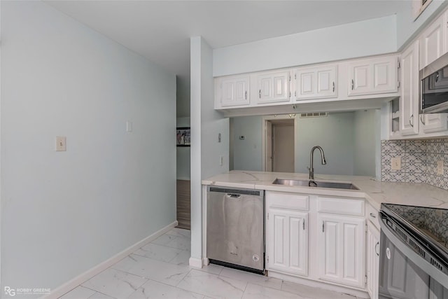 3100 Fairfield Ave Unit 8B, Shreveport, LA 71104 - kitchen with a sink, appliances with stainless steel finishes, light marble finish floors, baseboards, and decorative backsplash