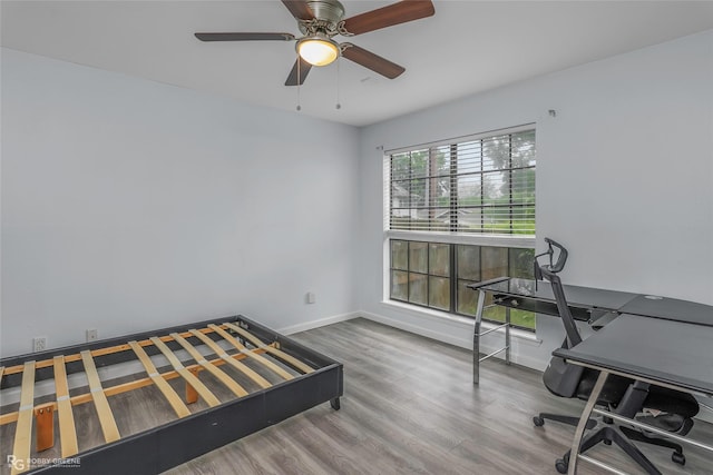 3100 Fairfield Ave Unit 8B, Shreveport, LA 71104 - bedroom featuring wood finished floors, baseboards, a ceiling fan, and an office area