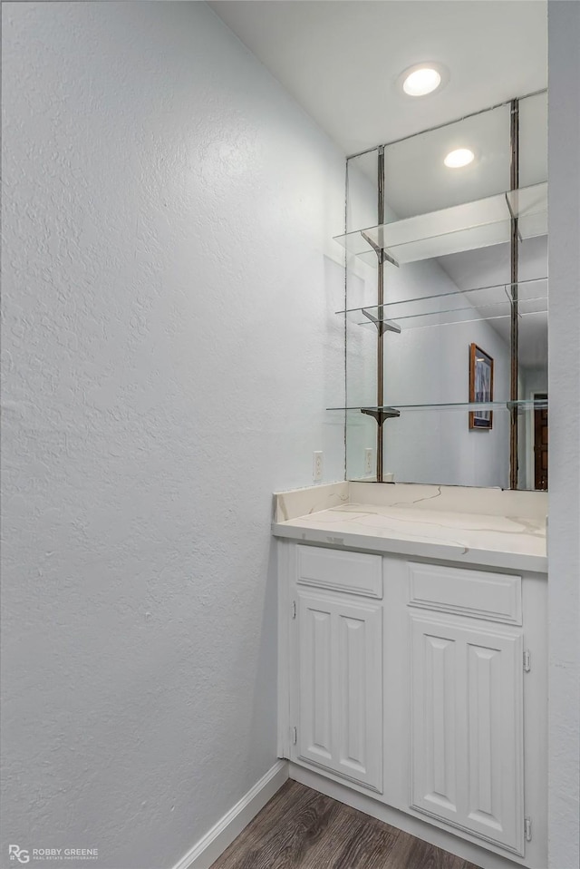 3100 Fairfield Ave Unit 8B, Shreveport, LA 71104 - bathroom featuring wood finished floors, vanity, a textured wall, and baseboards