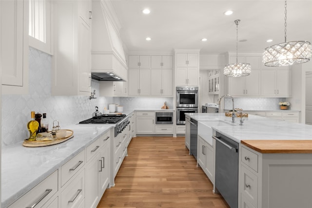 6946 Southridge Dr, Dallas, TX 75214 - kitchen with stainless steel appliances, white cabinetry, a sink, custom range hood, and decorative backsplash