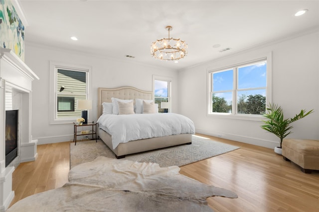 6946 Southridge Dr, Dallas, TX 75214 - bedroom featuring crown molding, a glass covered fireplace, a chandelier, baseboards, and light wood finished floors