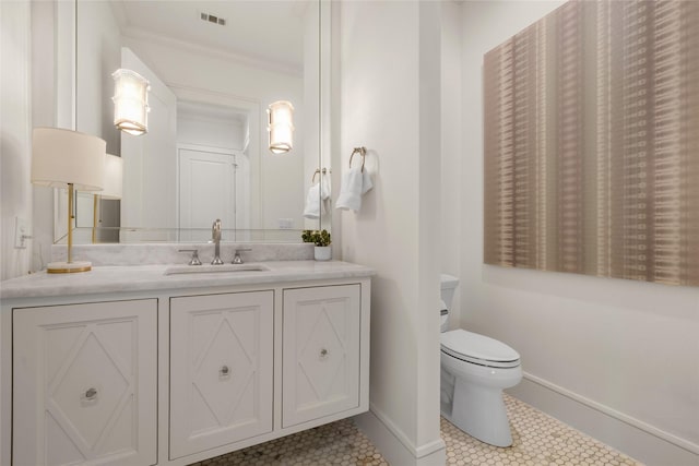 6946 Southridge Dr, Dallas, TX 75214 - bathroom featuring baseboards, vanity, toilet, tile patterned flooring, and ornamental molding