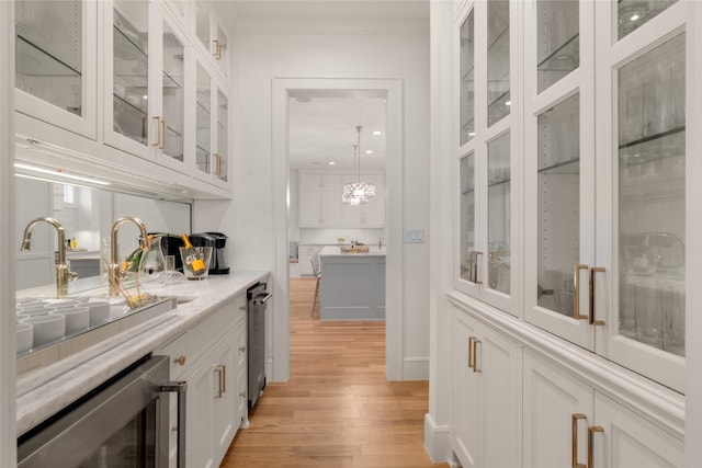 6946 Southridge Dr, Dallas, TX 75214 - bar area with wine cooler, light wood-type flooring, a sink, tasteful backsplash, and ornamental molding