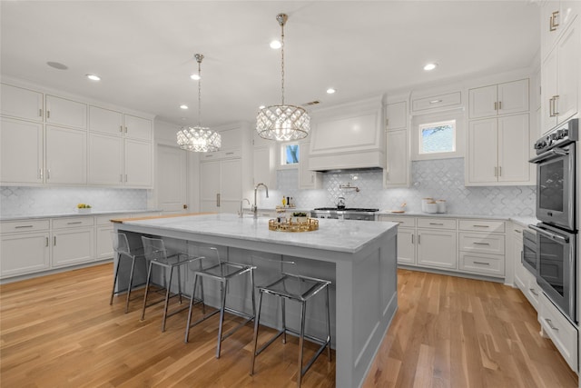 6946 Southridge Dr, Dallas, TX 75214 - kitchen with backsplash, a breakfast bar, white cabinets, double oven, and recessed lighting