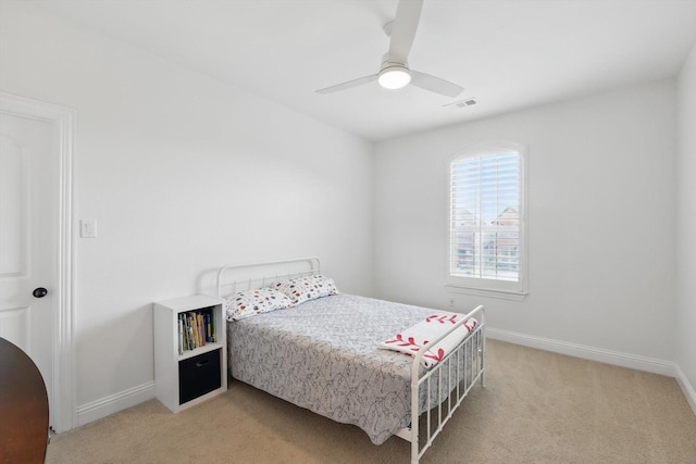 bedroom with light colored carpet, visible vents, ceiling fan, and baseboards