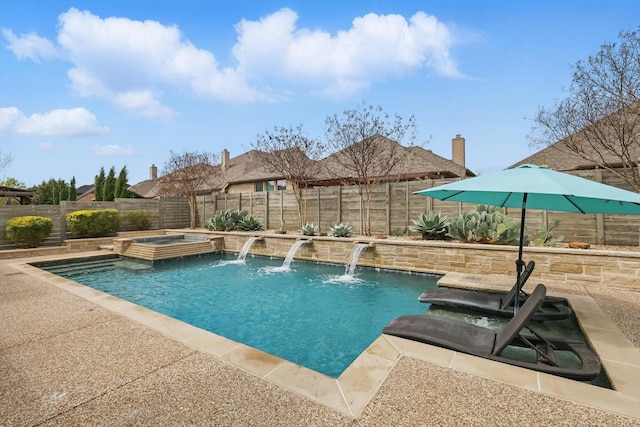 view of swimming pool with a fenced backyard, a pool with connected hot tub, and a patio