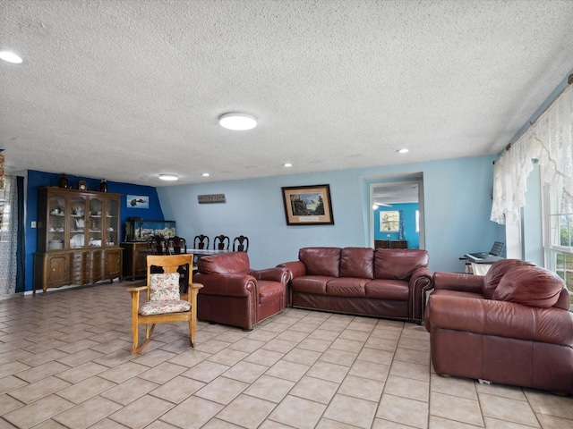 living area with light tile patterned flooring, a textured ceiling, and recessed lighting