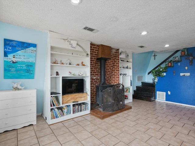 unfurnished living room with built in shelves and visible vents