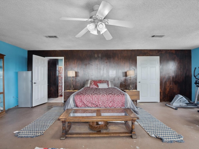 bedroom with visible vents, finished concrete floors, and a textured ceiling