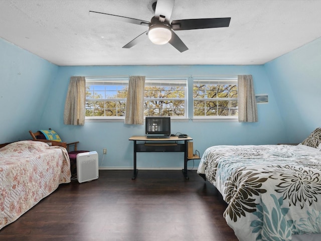 bedroom with a textured ceiling, baseboards, ceiling fan, and wood finished floors
