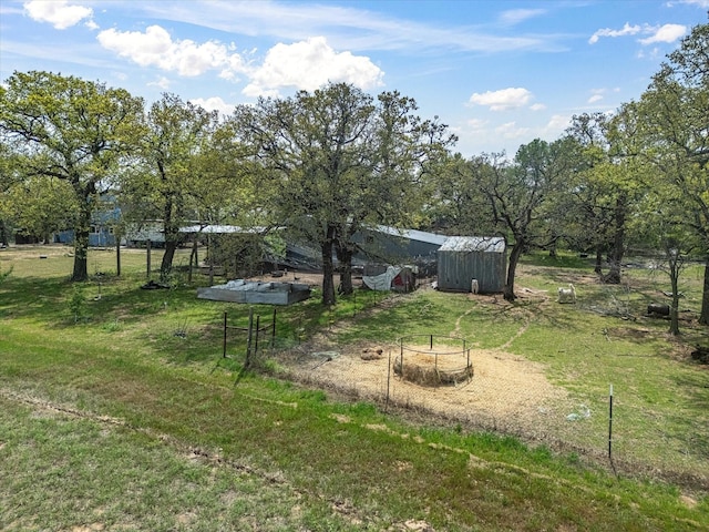 view of yard featuring an outbuilding and a storage shed
