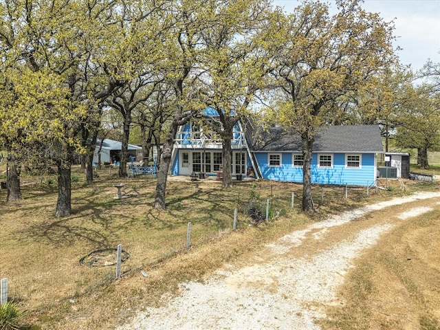 a-frame home with driveway and fence