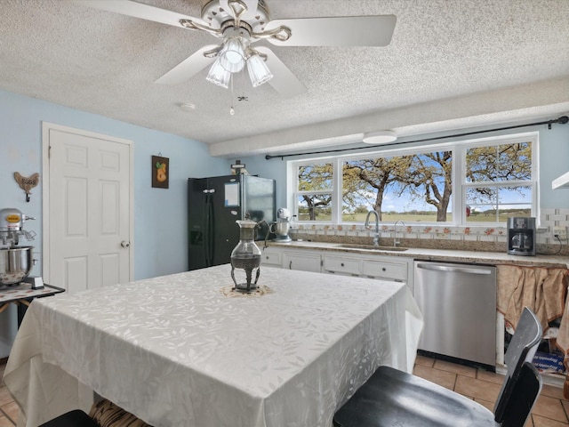 dining area with light tile patterned flooring, a textured ceiling, and a ceiling fan