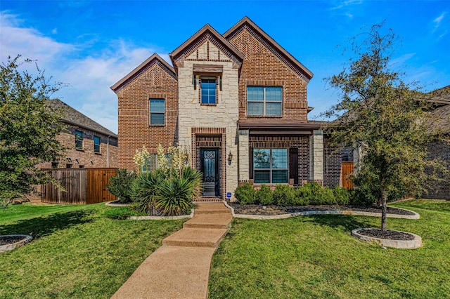1596 Mannheim Dr, Rockwall, TX 75032 - traditional home featuring fence, brick siding, a front lawn, and stone siding