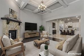 1596 Mannheim Dr, Rockwall, TX 75032 - living area featuring a fireplace, an inviting chandelier, beam ceiling, and coffered ceiling
