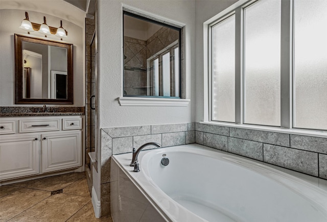 1596 Mannheim Dr, Rockwall, TX 75032 - full bathroom with a garden tub, vanity, a textured wall, tile patterned floors, and a shower stall