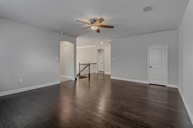 1596 Mannheim Dr, Rockwall, TX 75032 - spare room featuring ceiling fan, arched walkways, baseboards, dark wood-type flooring, and visible vents