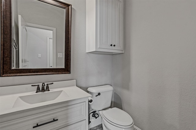 1596 Mannheim Dr, Rockwall, TX 75032 - bathroom featuring toilet, a textured wall, and vanity