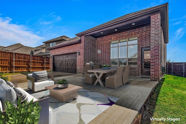 1596 Mannheim Dr, Rockwall, TX 75032 - deck featuring fence, outdoor dining space, an attached garage, outdoor lounge area, and a patio