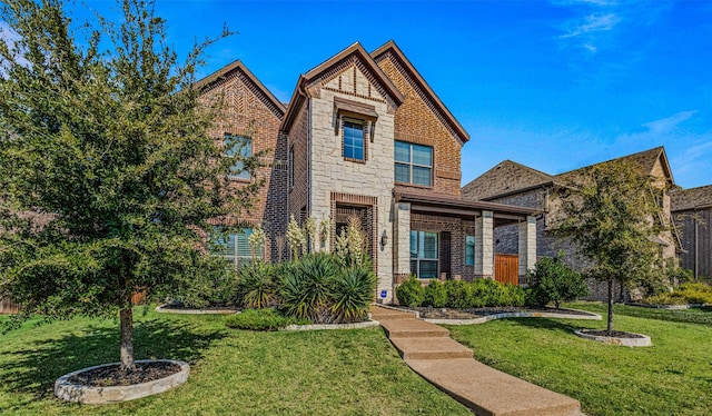 1596 Mannheim Dr, Rockwall, TX 75032 - view of front facade featuring brick siding, stone siding, and a front lawn