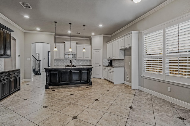 1596 Mannheim Dr, Rockwall, TX 75032 - kitchen with stainless steel microwave, visible vents, decorative backsplash, and a sink