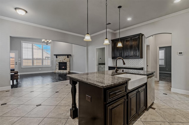 1596 Mannheim Dr, Rockwall, TX 75032 - kitchen with a stone fireplace, dishwasher, a sink, baseboards, and light tile patterned flooring