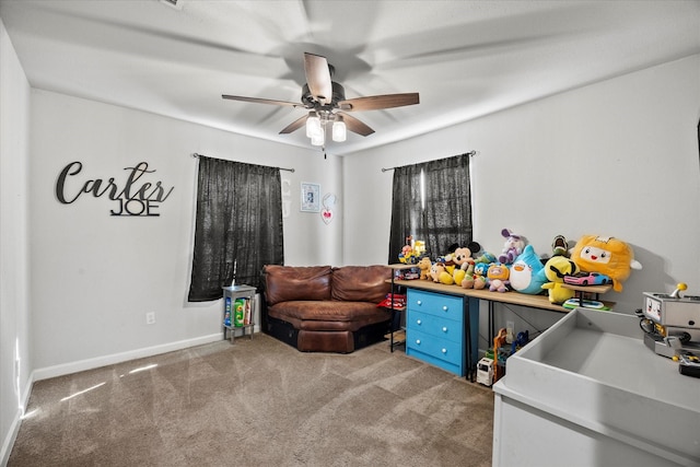 game room with baseboards, carpet floors, and a ceiling fan