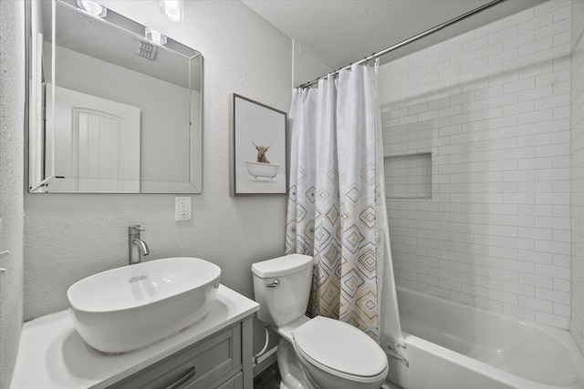 bathroom featuring shower / bath combination with curtain, toilet, vanity, and a textured wall