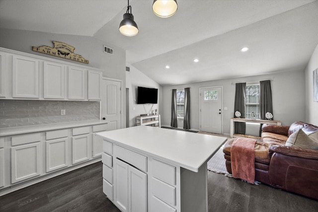kitchen with open floor plan, dark wood-style flooring, white cabinetry, and lofted ceiling