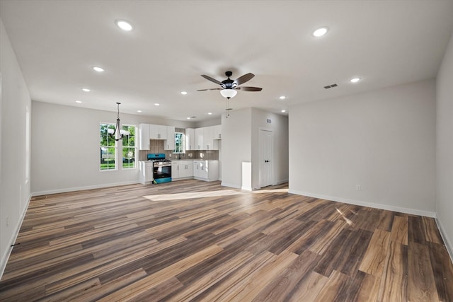 unfurnished living room with recessed lighting, ceiling fan, baseboards, and wood finished floors