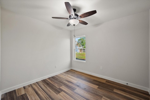 empty room featuring ceiling fan, baseboards, and dark wood-style floors