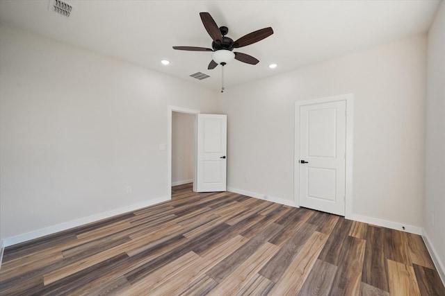unfurnished room with wood finished floors, ceiling fan, recessed lighting, and baseboards