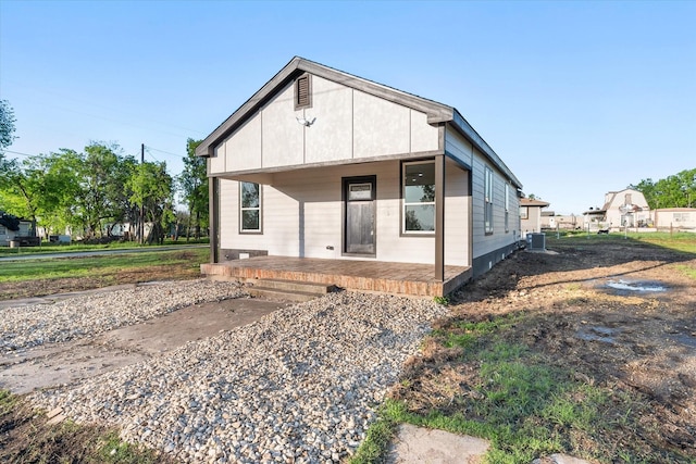 back of property with a porch and central air condition unit