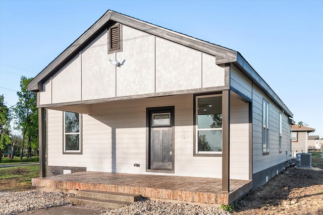 back of house featuring cooling unit
