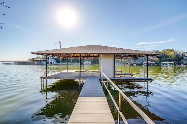 dock area with a water view and boat lift