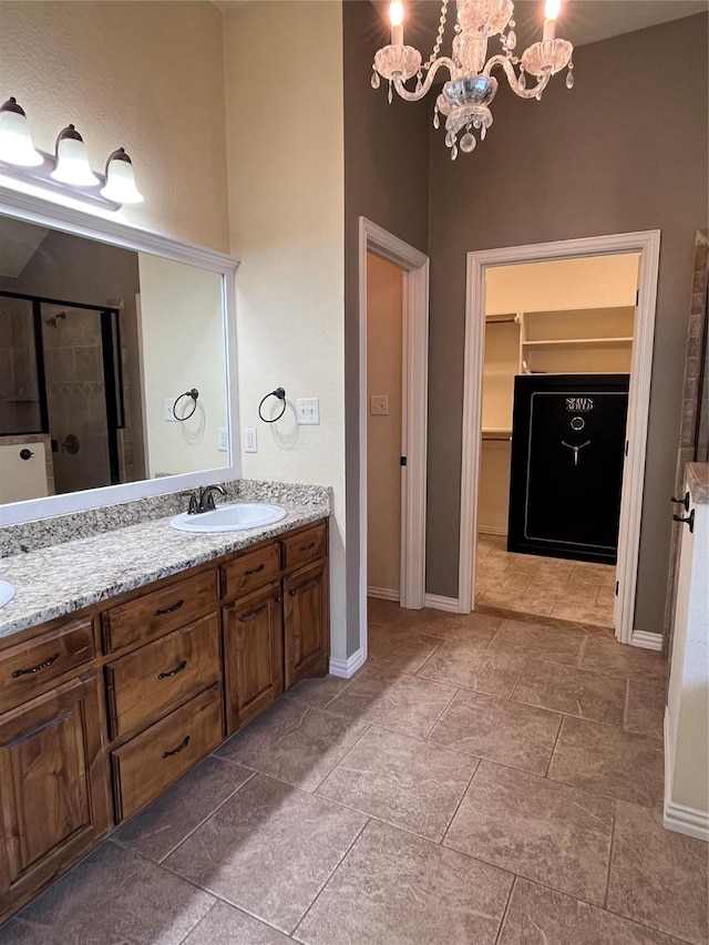 4315 Logan Cir, Granbury, TX 76049 - full bath with double vanity, a shower stall, a walk in closet, a chandelier, and baseboards