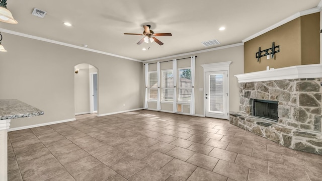 4315 Logan Cir, Granbury, TX 76049 - unfurnished living room featuring a ceiling fan, arched walkways, a stone fireplace, baseboards, and crown molding