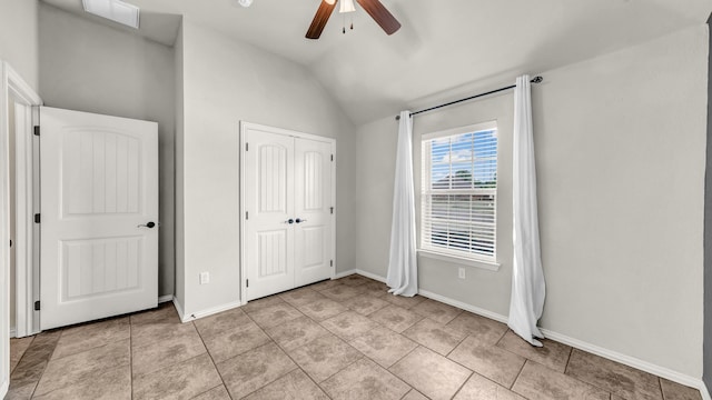 4315 Logan Cir, Granbury, TX 76049 - unfurnished bedroom with vaulted ceiling, baseboards, a closet, a ceiling fan, and light tile patterned floors
