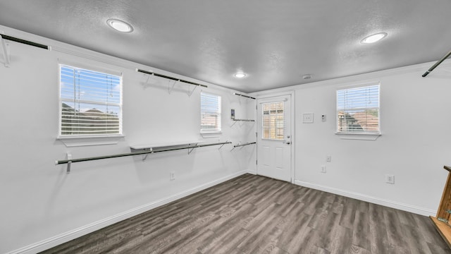 4315 Logan Cir, Granbury, TX 76049 - spare room featuring wood finished floors, a textured ceiling, baseboards, and recessed lighting