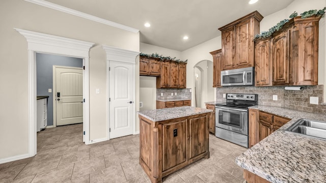 4315 Logan Cir, Granbury, TX 76049 - kitchen with stainless steel appliances, a center island, decorative backsplash, baseboards, and recessed lighting