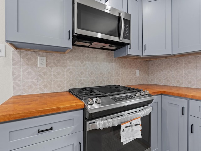 5134 Anderson Cir, Garland, TX 75043 - kitchen with stainless steel appliances, wooden counters, and tasteful backsplash