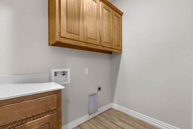 2685 Thompson Rd, Weatherford, TX 76087 - laundry room featuring cabinet space, hookup for a washing machine, baseboards, light wood-style flooring, and electric dryer hookup