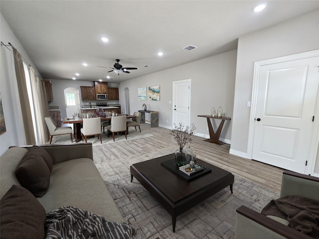 2685 Thompson Rd, Weatherford, TX 76087 - living room featuring arched walkways, recessed lighting, ceiling fan, light wood finished floors, and baseboards