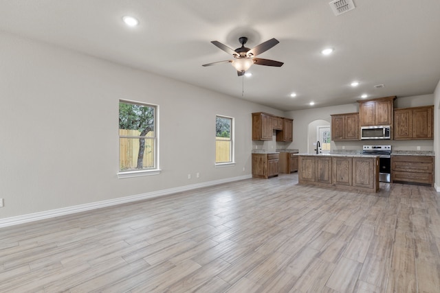 2685 Thompson Rd, Weatherford, TX 76087 - kitchen featuring stainless steel appliances, open floor plan, a ceiling fan, baseboards, and a kitchen island