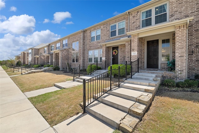 7223 Sideoats Gama St, Frisco, TX 75033 - townhome / multi-family property with a residential view, brick siding, and a front yard